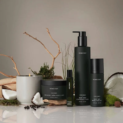 Front view of Homecourt Cocomoi body wash, body mist, body butter and perfume oil in matte green packaging with coconut and moss