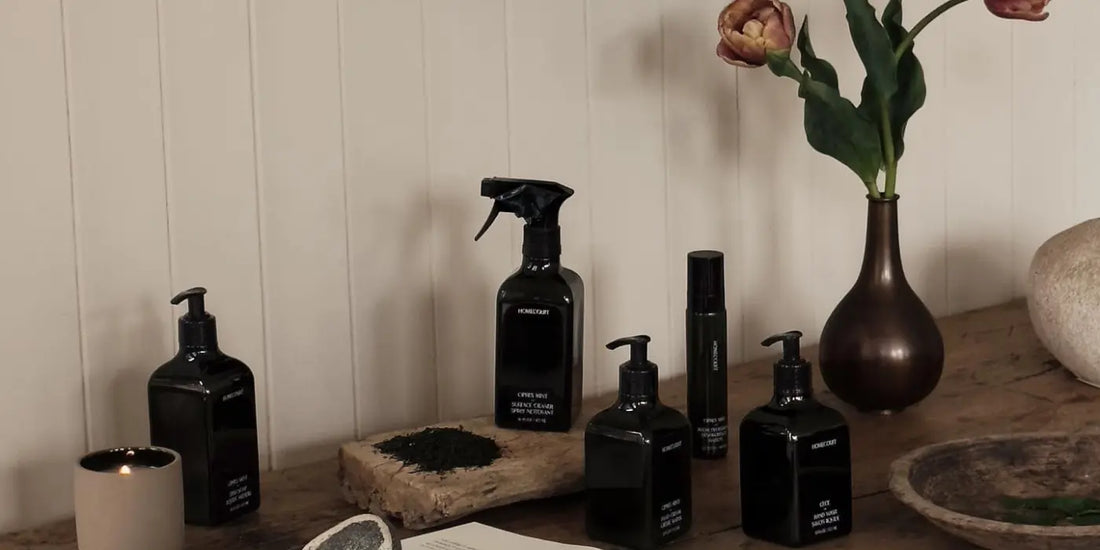 All-natural room deodorizer products arranged on a rustic wood table with fresh flowers and elegant decor.