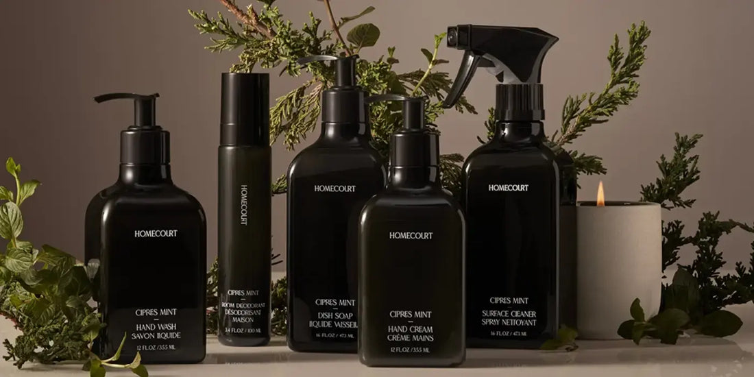 Healthy dish detergent and complete Homecourt Cipres Mint cleaning collection styled with greenery and a candle.