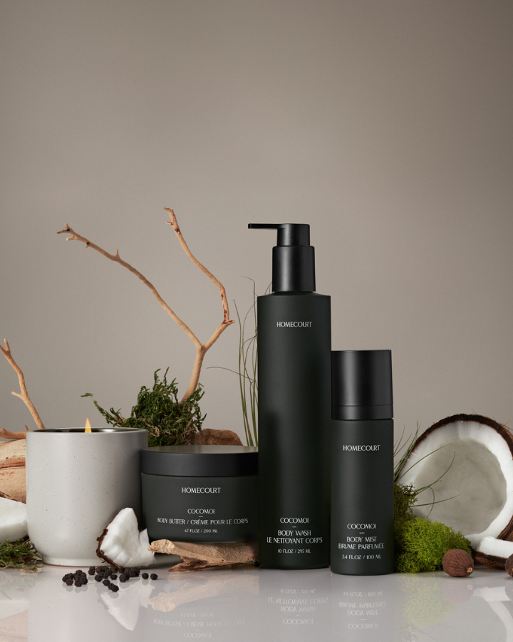 Set of black skincare products with natural elements on a neutral background