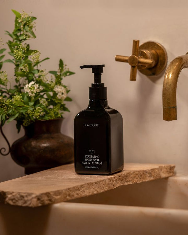 black bottle exfoliating hand wash on a sink