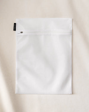 Laundry delicates bag with zipper, designed to protect fragile clothing during machine washing.